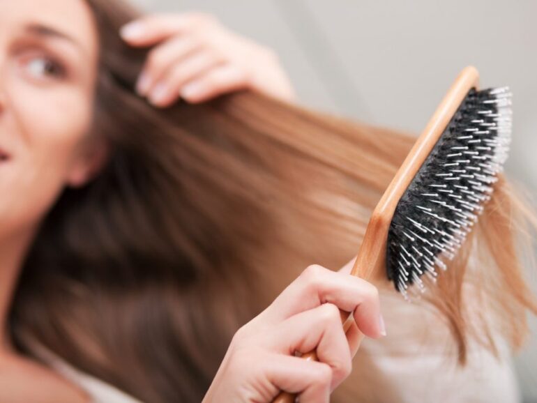 women brushing hair extensions